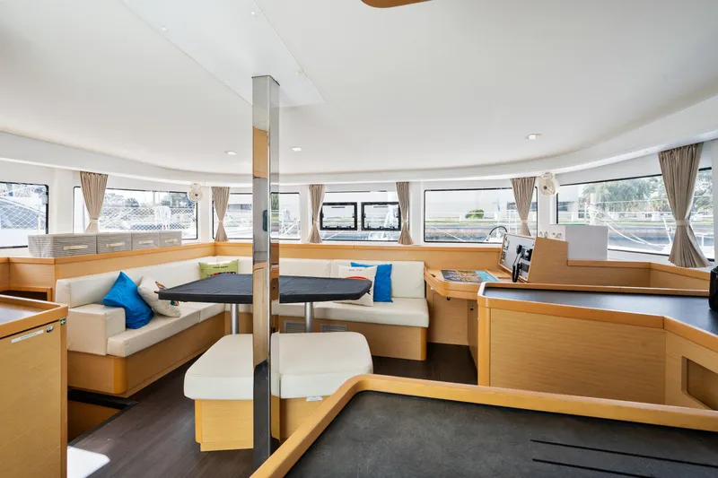 Slide: The Image of Spacious interior of 2018 Lagoon 42 catamaran with modern furnishings and panoramic windows. - 49