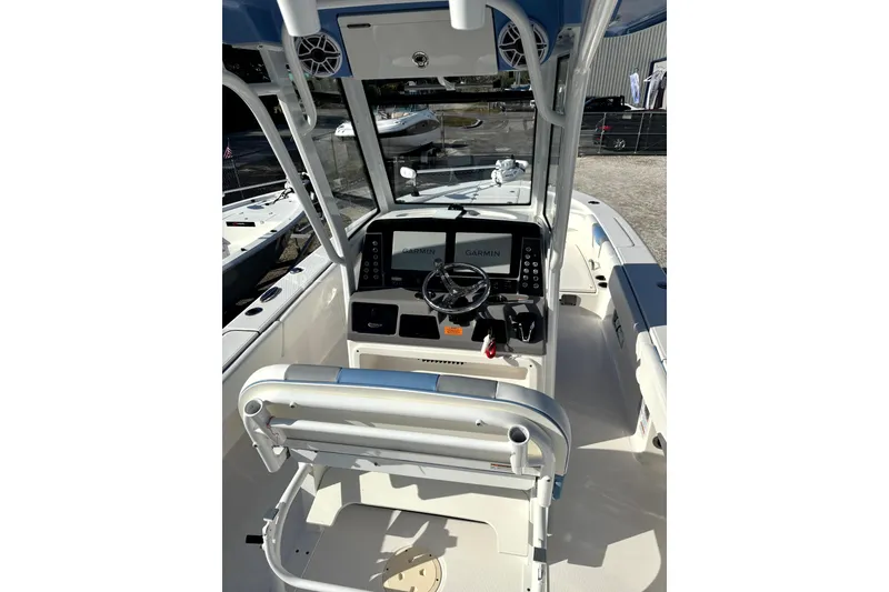 Slide: The Image of 2023 Robalo 266 Cayman boat cockpit with Garmin navigation system and steering wheel. - 17