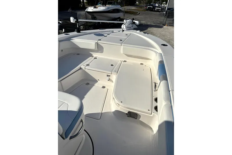 Slide: The Image of 2023 Robalo 266 Cayman boat interior with spacious seating and storage compartments. - 18