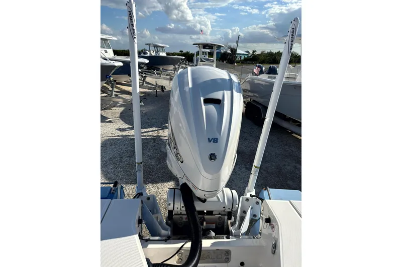 Slide: The Image of 2023 Robalo 266 Cayman boat with V8 engine, docked under a clear sky. - 20
