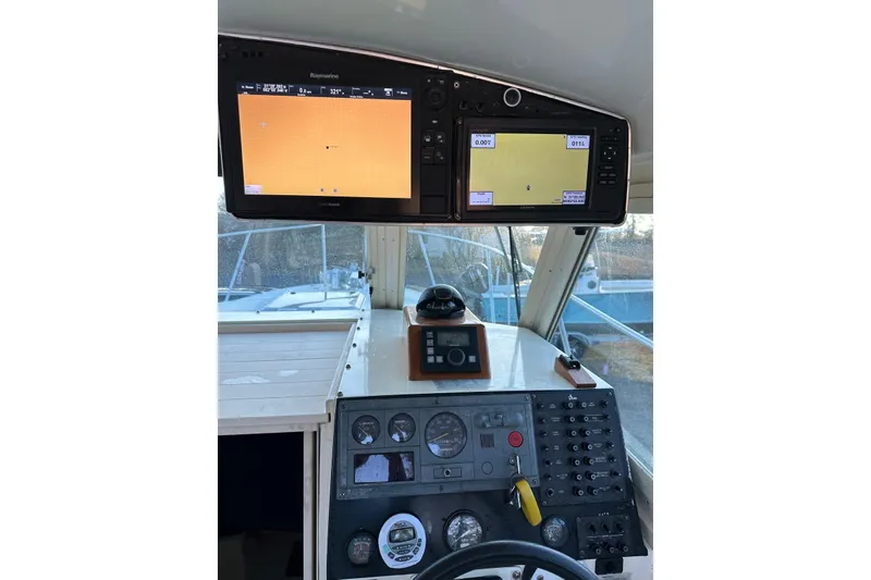 Slide: The Image of Cockpit of 2000 Albin 28 Tournament Express with navigation displays and control panel. - 14