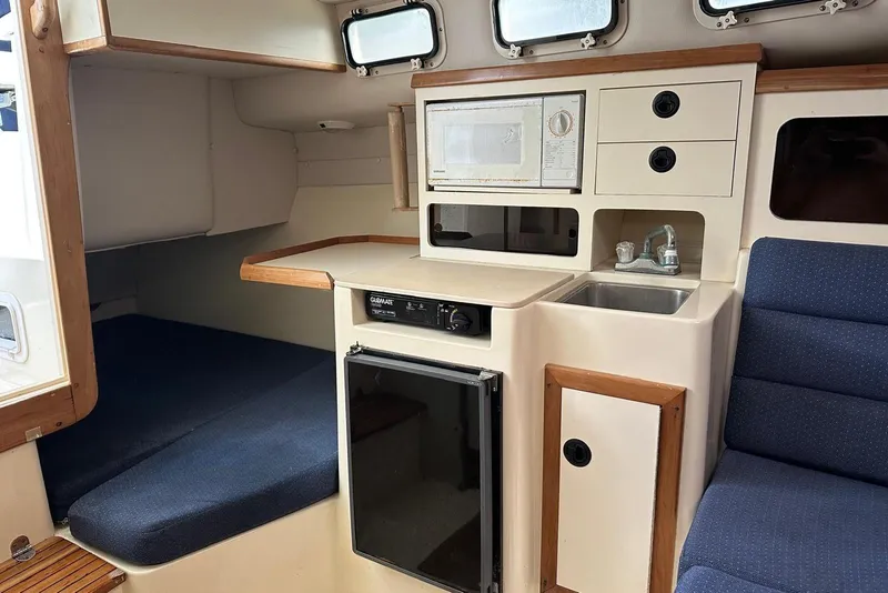 Slide: The Image of Interior of 2000 Albin 28 Tournament Express with kitchenette and seating area. - 15