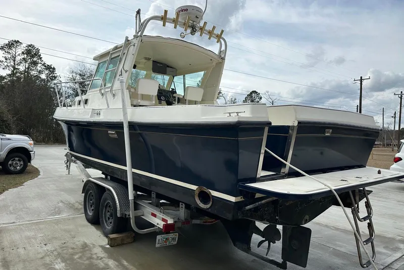 Slide: The Image of 2000 Albin 28 Tournament Express boat on trailer, parked outdoors. - 2