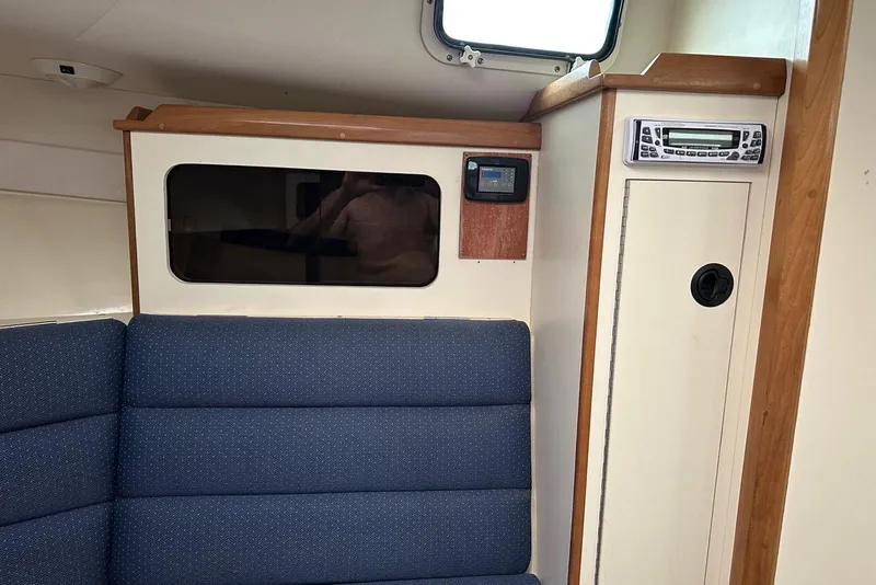 Slide: The Image of Interior of 2000 Albin 28 Tournament Express with blue seating and wooden accents. - 20