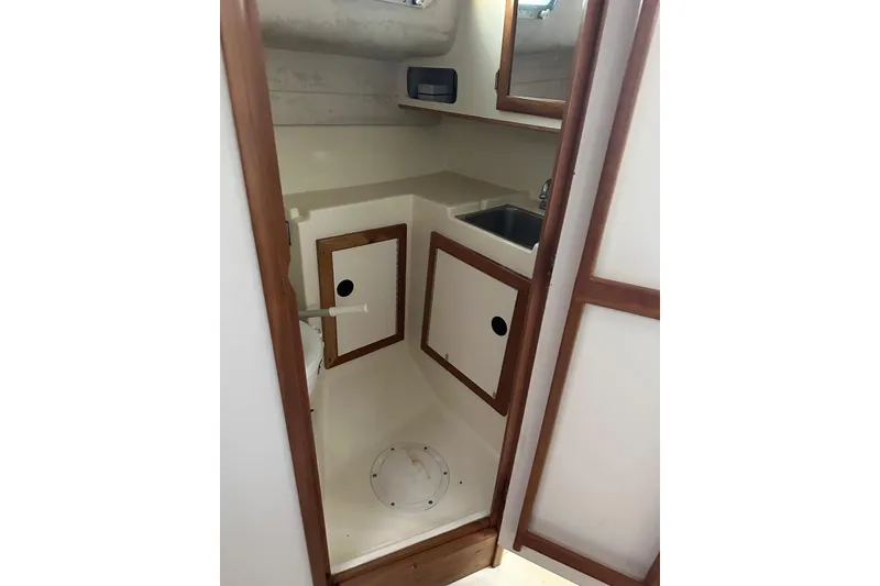 Slide: The Image of 2000 Albin 28 Tournament Express cabin interior with sink and storage. - 24