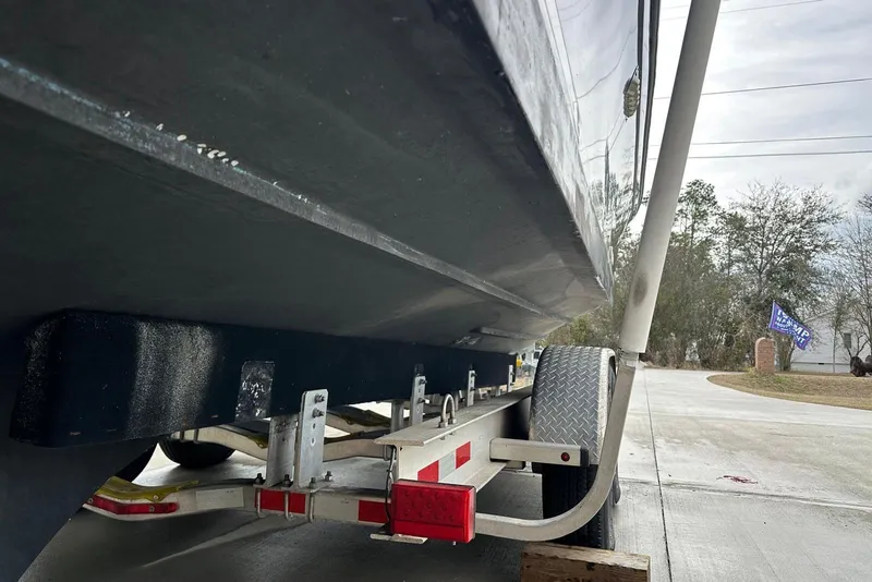 Slide: The Image of Trailer supporting a 2000 Albin 28 Tournament Express boat, parked on a driveway. - 26