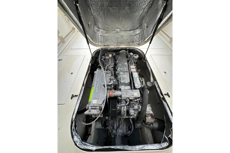 Slide: The Image of Engine compartment of a 2000 Albin 28 Tournament Express boat, showcasing detailed machinery. - 30