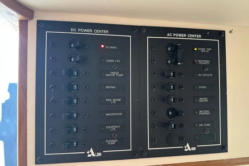 Slide: The Image of Control panel of a 2000 Albin 28 Tournament Express boat, featuring DC and AC power centers. - 33