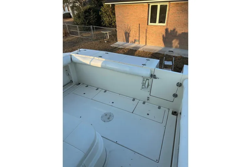 Slide: The Image of 2000 Albin 28 Tournament Express boat deck, featuring storage compartments and seating. - 35