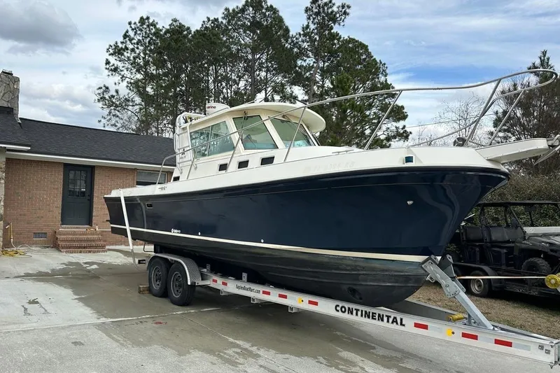 Slide: The Image of Albin 28 Tournament Express 2000 on trailer in front of house. - 4