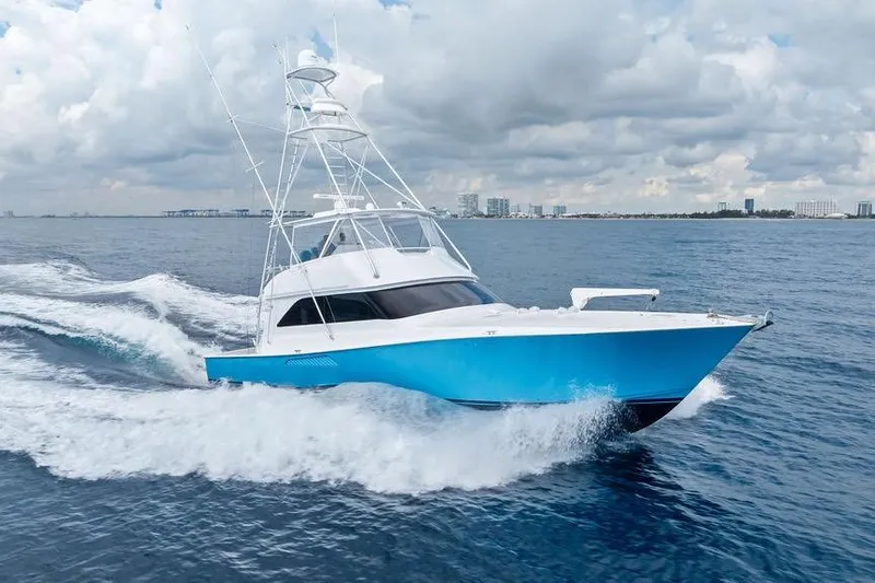 The Image of 2005 Viking 61 Convertible yacht cruising on open water under cloudy skies. - 0