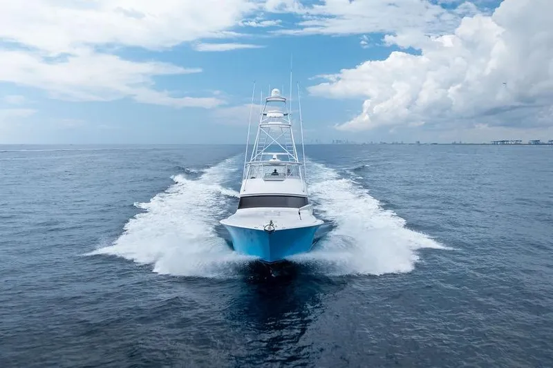 Slide: The Image of 2005 Viking 61 Convertible yacht cruising on open ocean under blue sky. - 1
