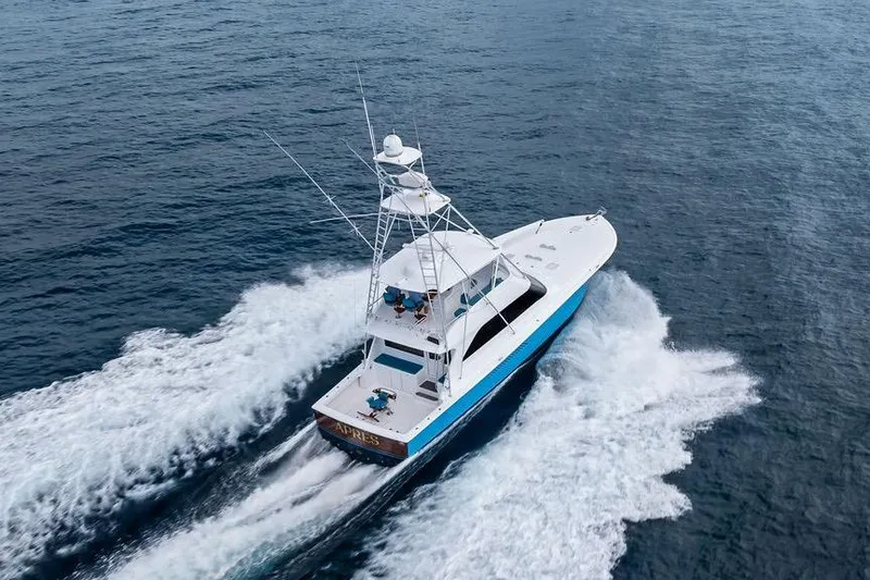 Slide: The Image of 2005 Viking 61 Convertible yacht cruising on open water, aerial view. - 10