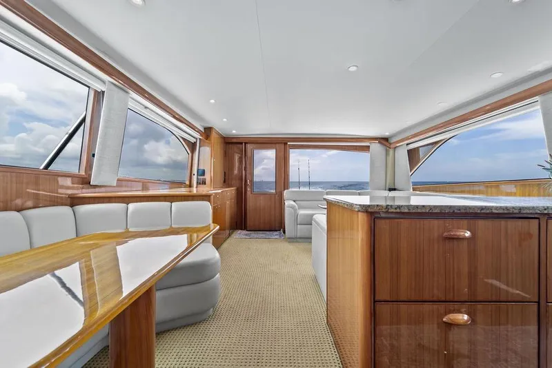 Slide: The Image of Luxurious interior of a 2005 Viking 61 Convertible yacht with elegant wood finishes and panoramic windows. - 12
