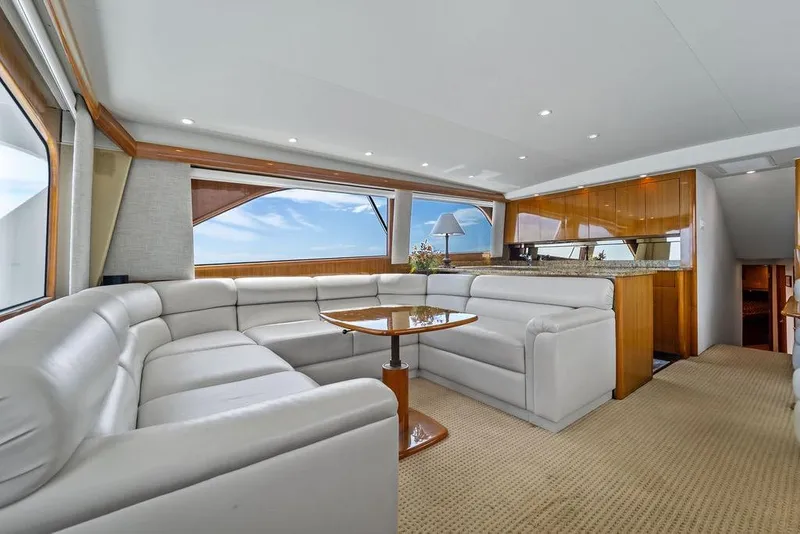Slide: The Image of Luxurious interior of 2005 Viking 61 Convertible yacht with plush seating and elegant wood finishes. - 14