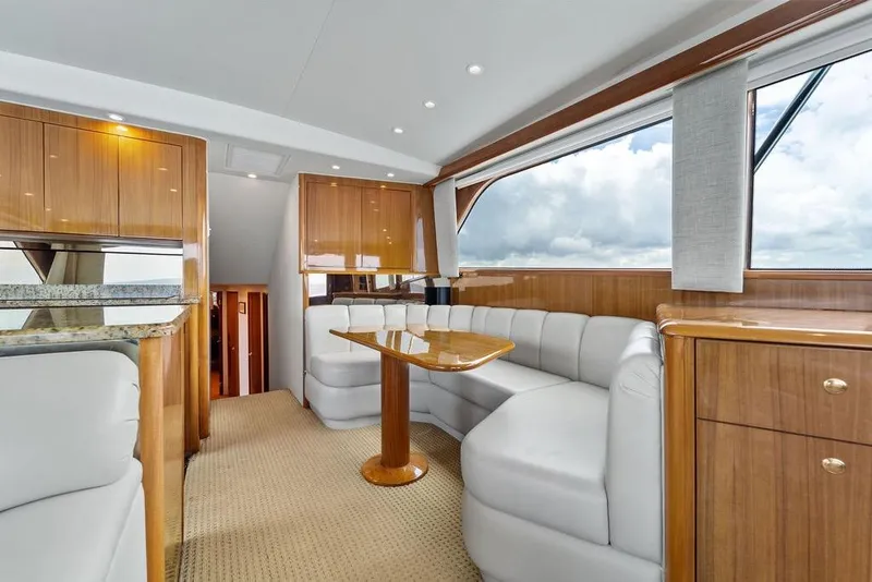 Slide: The Image of Luxurious interior of a 2005 Viking 61 Convertible yacht with elegant wood finishes. - 17
