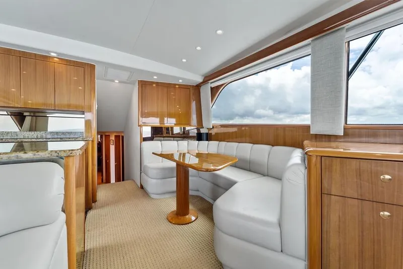 Slide: The Image of Luxurious interior of 2005 Viking 61 Convertible yacht with elegant wood finishes and plush seating. - 18