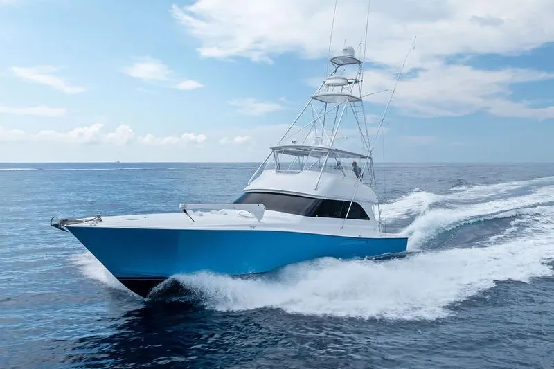 Slide: The Image of 2005 Viking 61 Convertible yacht cruising on open ocean under clear skies. - 2