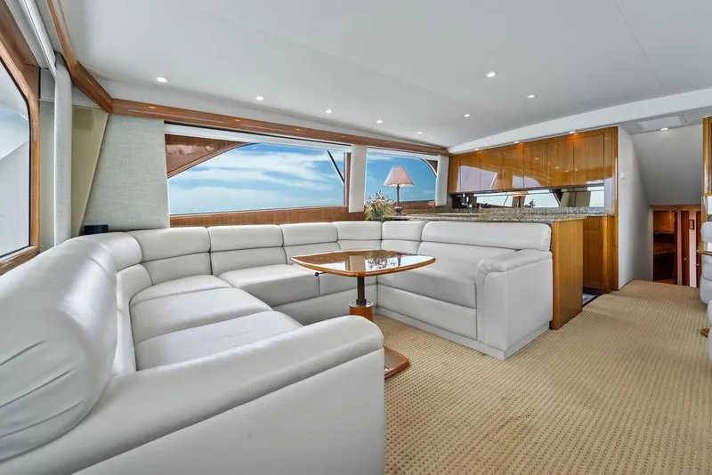 Slide: The Image of Luxurious interior of 2005 Viking 61 Convertible yacht with white leather seating and wooden accents. - 20