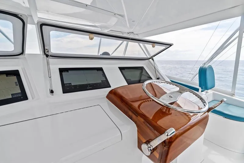 Slide: The Image of Helm of 2005 Viking 61 Convertible yacht with modern navigation displays and ocean view. - 21