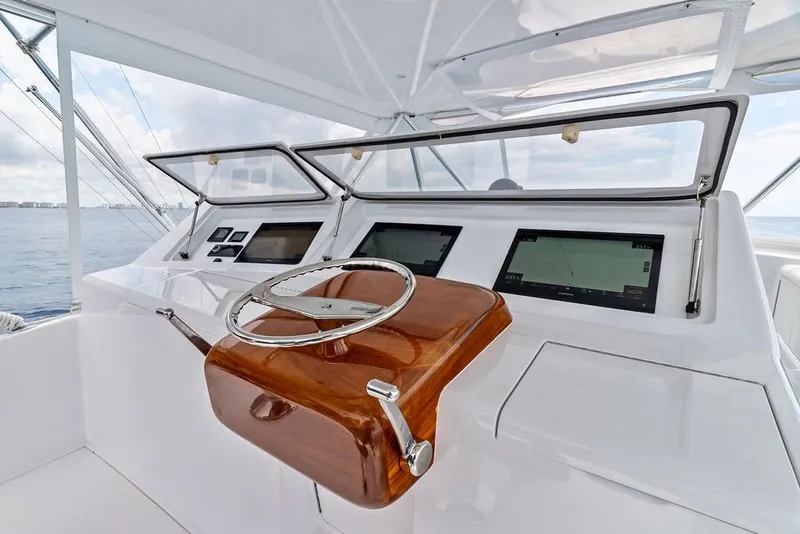 Slide: The Image of Helm of 2005 Viking 61 Convertible yacht with modern navigation displays. - 23