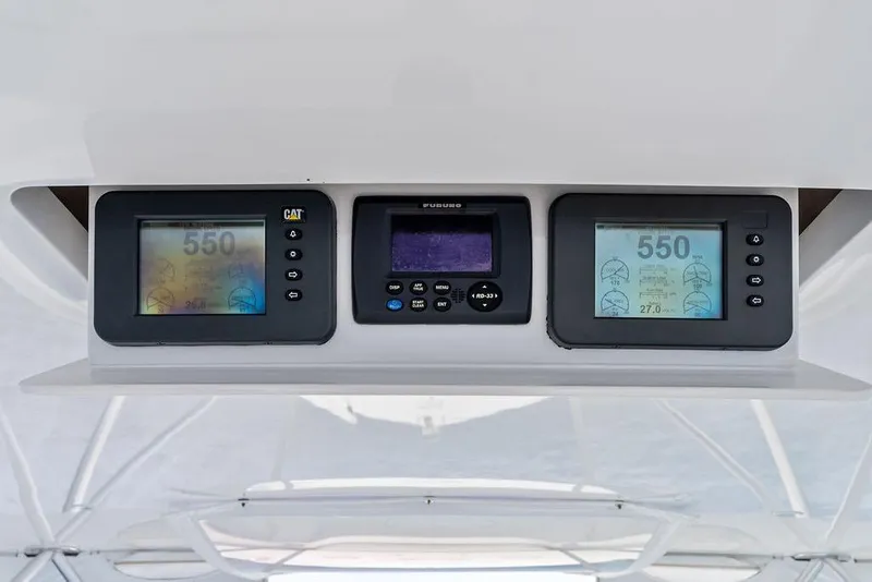Slide: The Image of Control panel of a 2005 Viking 61 Convertible yacht with digital displays. - 24