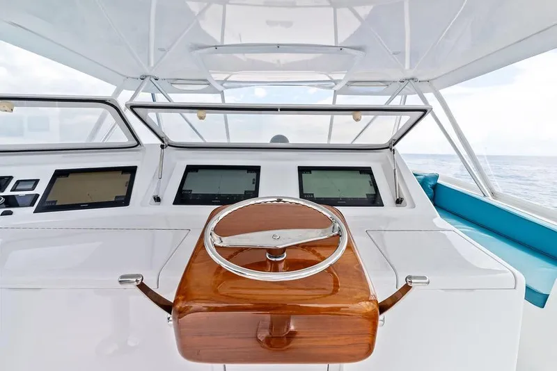 Slide: The Image of Helm of 2005 Viking 61 Convertible yacht with modern navigation displays and wooden steering wheel. - 26