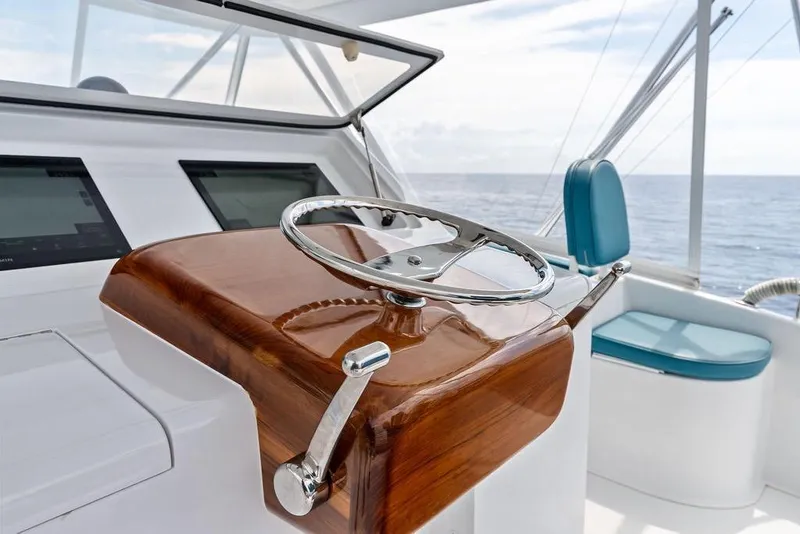 Slide: The Image of Steering wheel of a 2005 Viking 61 Convertible yacht with ocean view. - 27