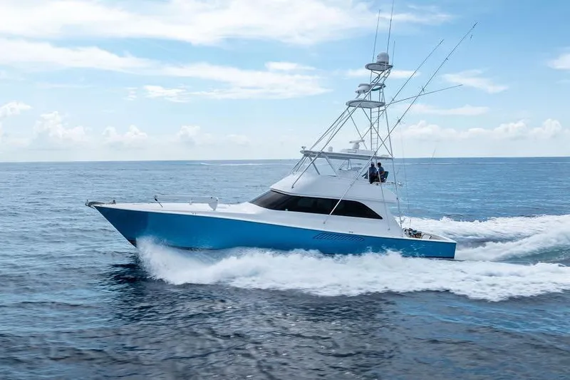 Slide: The Image of 2005 Viking 61 Convertible yacht cruising on open ocean under clear blue sky. - 3