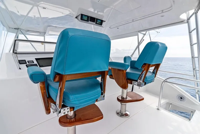 Slide: The Image of Luxurious helm chairs on a 2005 Viking 61 Convertible yacht, overlooking the ocean. - 32