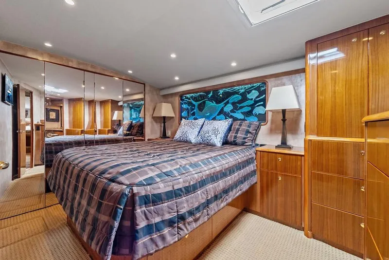 Slide: The Image of Luxurious bedroom interior of 2005 Viking 61 Convertible yacht with elegant wood finishes. - 34