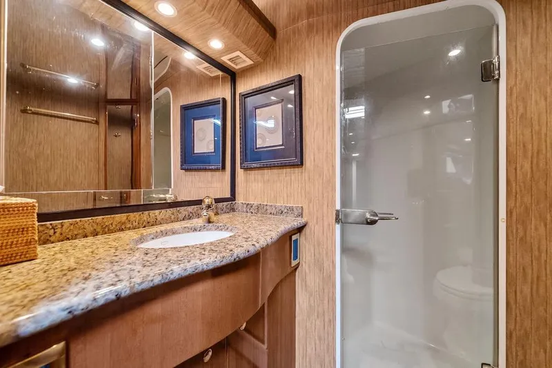 Slide: The Image of Luxurious bathroom in 2005 Viking 61 Convertible yacht with granite countertop and glass shower. - 36