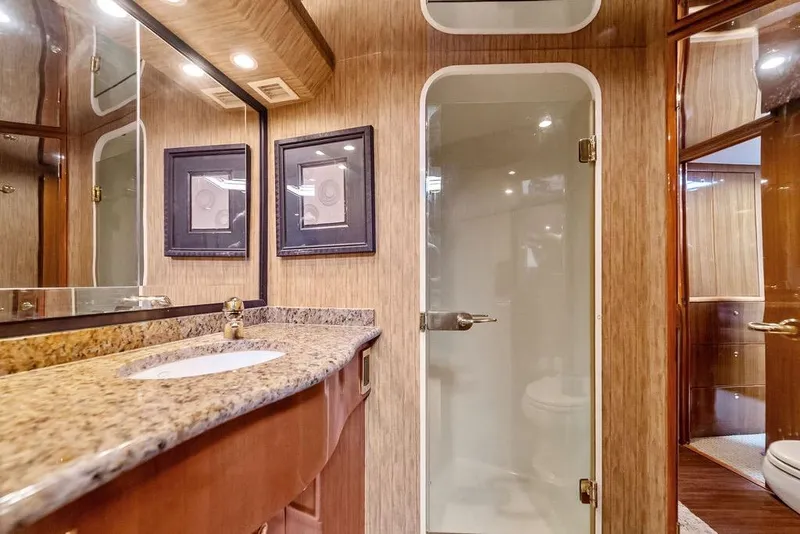 Slide: The Image of Luxurious bathroom in a 2005 Viking 61 Convertible yacht with granite countertop and glass shower. - 37