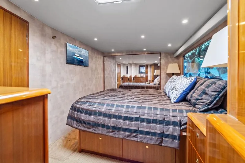 Slide: The Image of Luxurious bedroom interior of 2005 Viking 61 Convertible yacht with elegant wood finishes. - 38