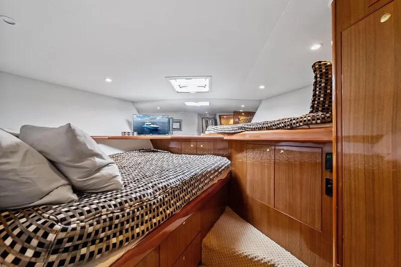 Slide: The Image of Luxurious cabin interior of 2005 Viking 61 Convertible yacht with cozy bedding. - 39