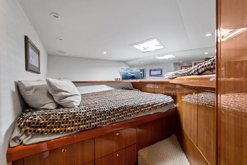 Slide: The Image of Luxurious cabin interior of a 2005 Viking 61 Convertible yacht with cozy bedding. - 40