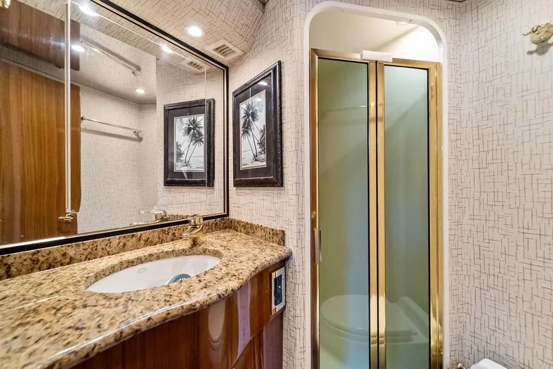 Slide: The Image of Luxurious bathroom in 2005 Viking 61 Convertible yacht with granite countertop and glass shower. - 41