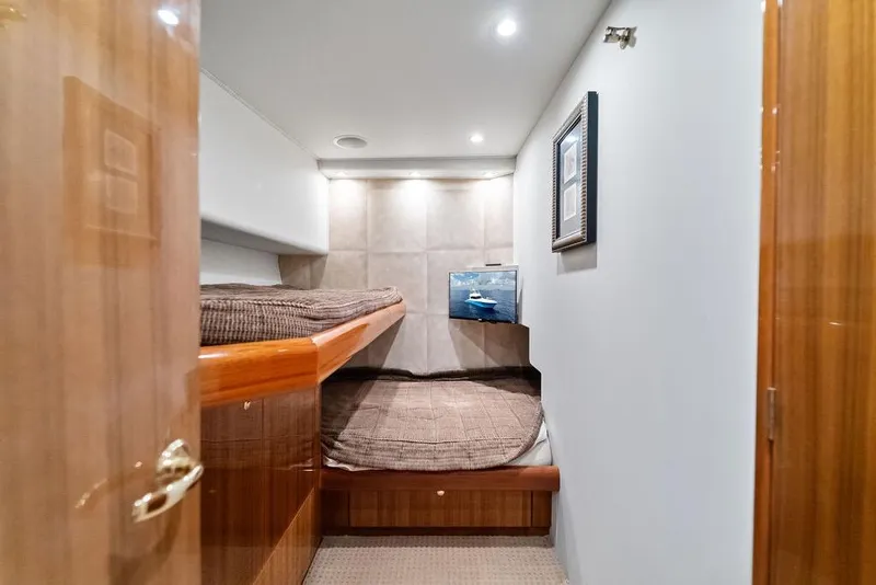 Slide: The Image of Interior of 2005 Viking 61 Convertible yacht with cozy bunk beds and elegant wood finish. - 44