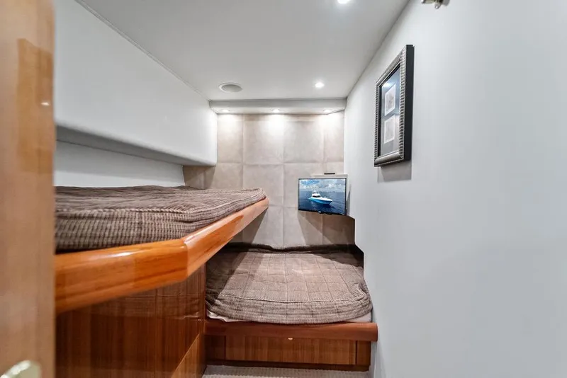 Slide: The Image of Interior cabin of 2005 Viking 61 Convertible yacht with bunk beds and framed artwork. - 45