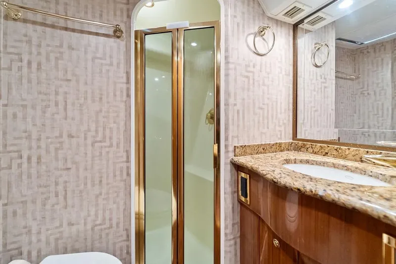 Slide: The Image of Luxurious bathroom in 2005 Viking 61 Convertible yacht with granite countertop and glass shower. - 46