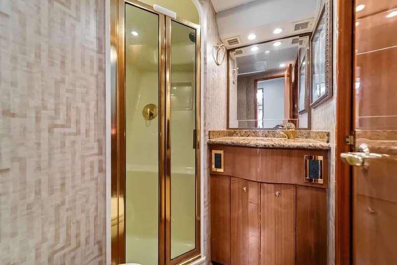 Slide: The Image of Luxurious bathroom in 2005 Viking 61 Convertible yacht with gold accents and granite countertop. - 47