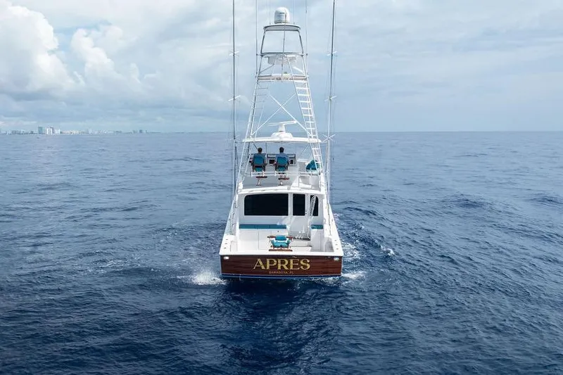 Slide: The Image of 2005 Viking 61 Convertible yacht "APRES" cruising on open ocean under cloudy sky. - 48