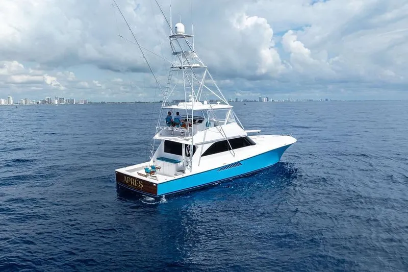 Slide: The Image of 2005 Viking 61 Convertible yacht cruising on open ocean under cloudy sky. - 49