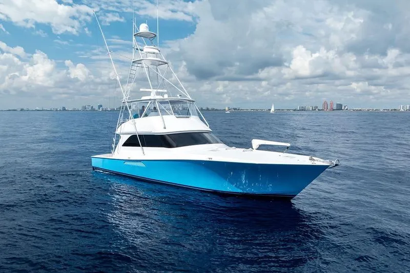 Slide: The Image of 2005 Viking 61 Convertible yacht on open sea under cloudy sky. - 51
