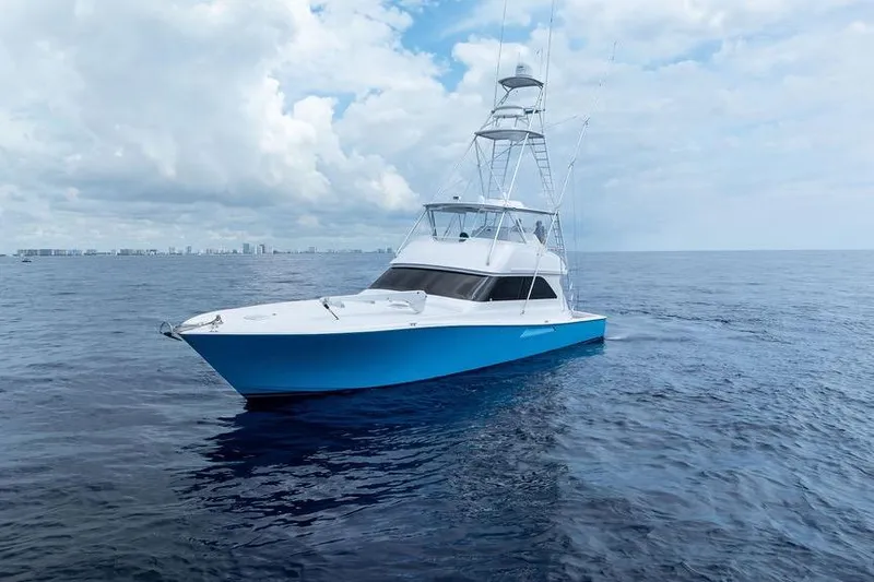 Slide: The Image of 2005 Viking 61 Convertible yacht on open ocean under cloudy sky. - 53