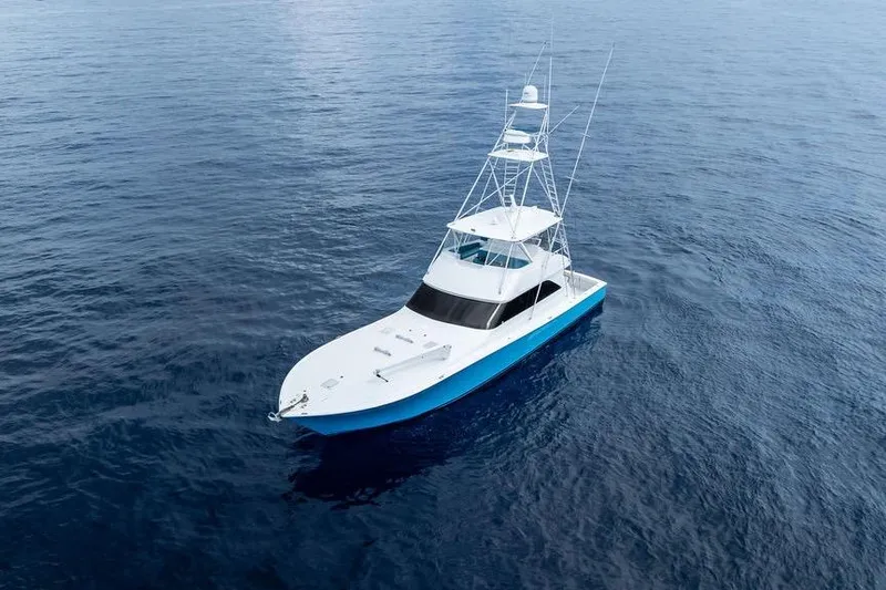 Slide: The Image of 2005 Viking 61 Convertible yacht cruising on open ocean waters. - 54
