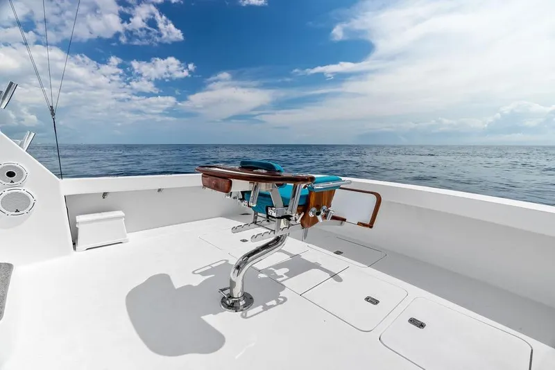 Slide: The Image of Fishing chair on 2005 Viking 61 Convertible yacht deck, overlooking the ocean under a blue sky. - 63