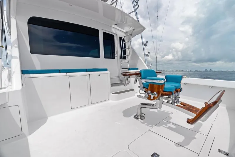 Slide: The Image of 2005 Viking 61 Convertible yacht deck with blue seating and ocean view. - 64