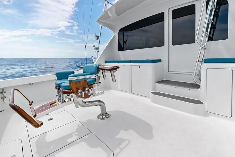 Slide: The Image of 2005 Viking 61 Convertible yacht deck with fishing chair, ocean view, and blue sky. - 65