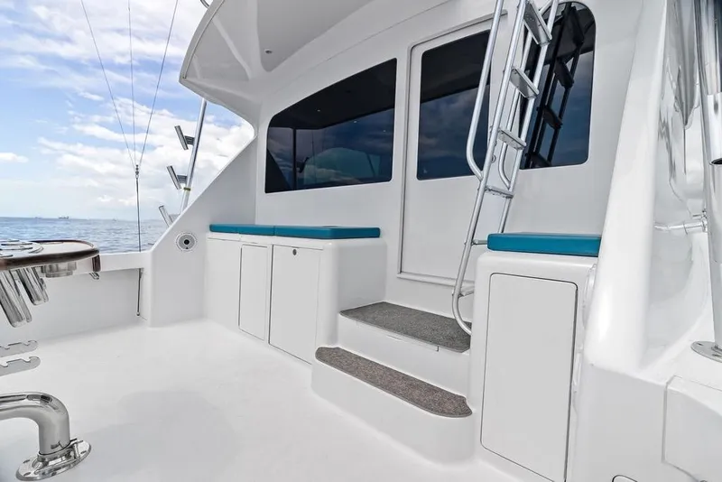 Slide: The Image of 2005 Viking 61 Convertible yacht deck with seating, ladder, and ocean view. - 67